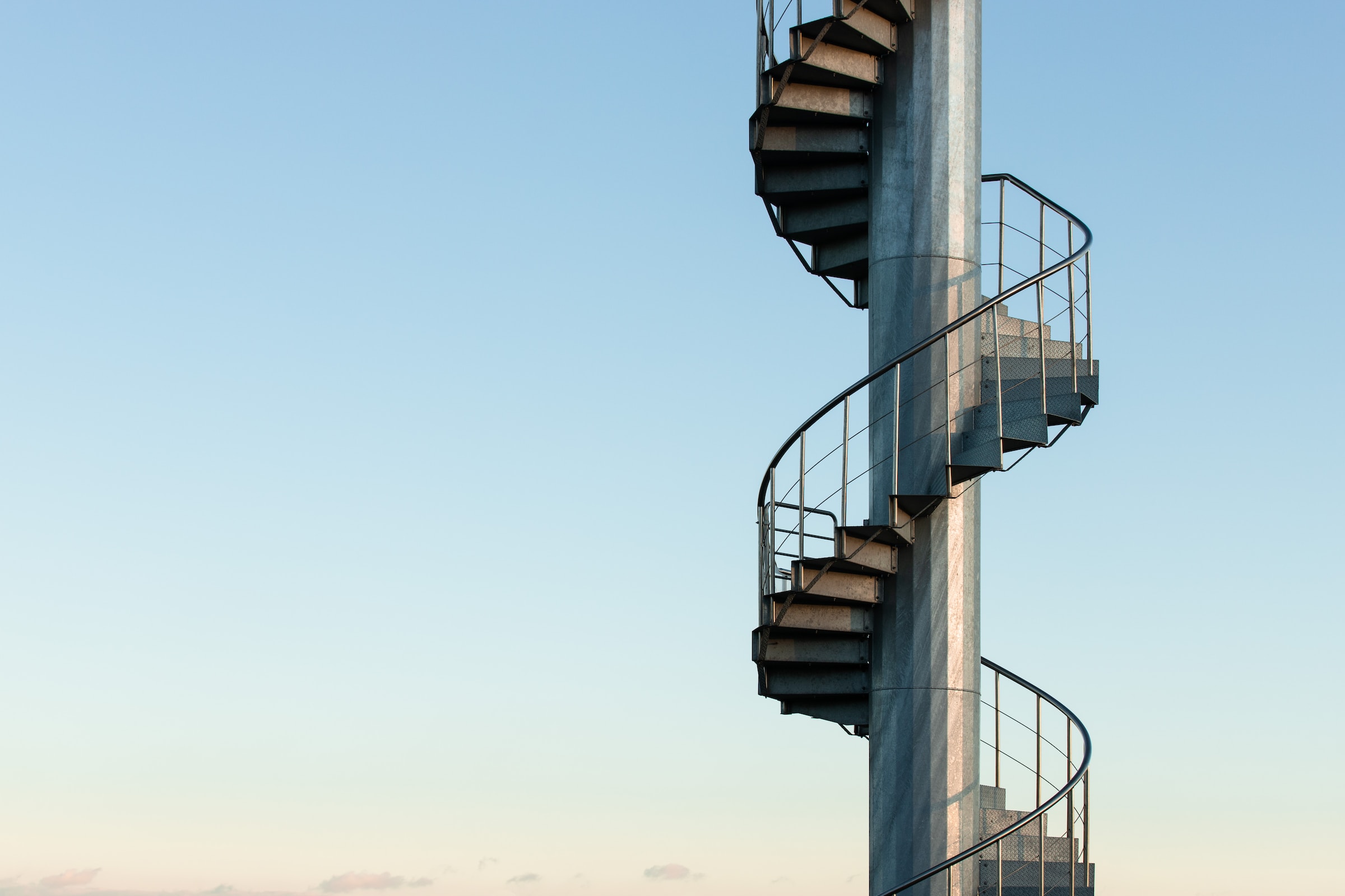 Image of a staircase winding up into the sky